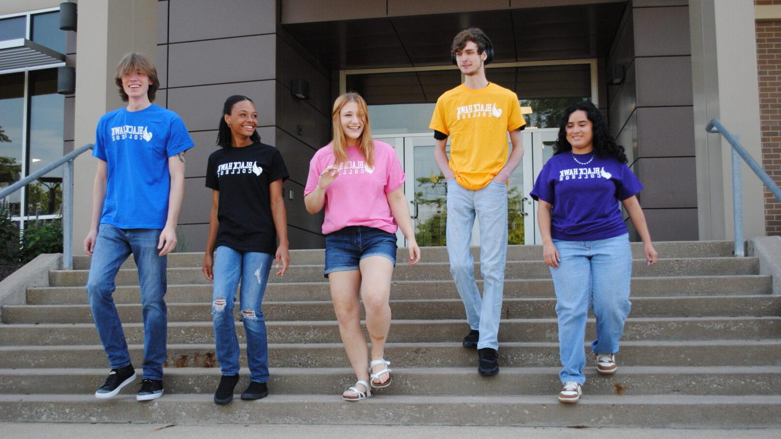 Five students walk down the stairs outside Black Hawk College.